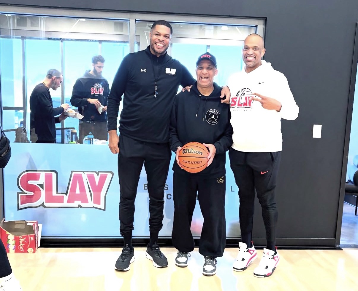 Ashaunte McLean with coaches at a SLAY Basketball facility
